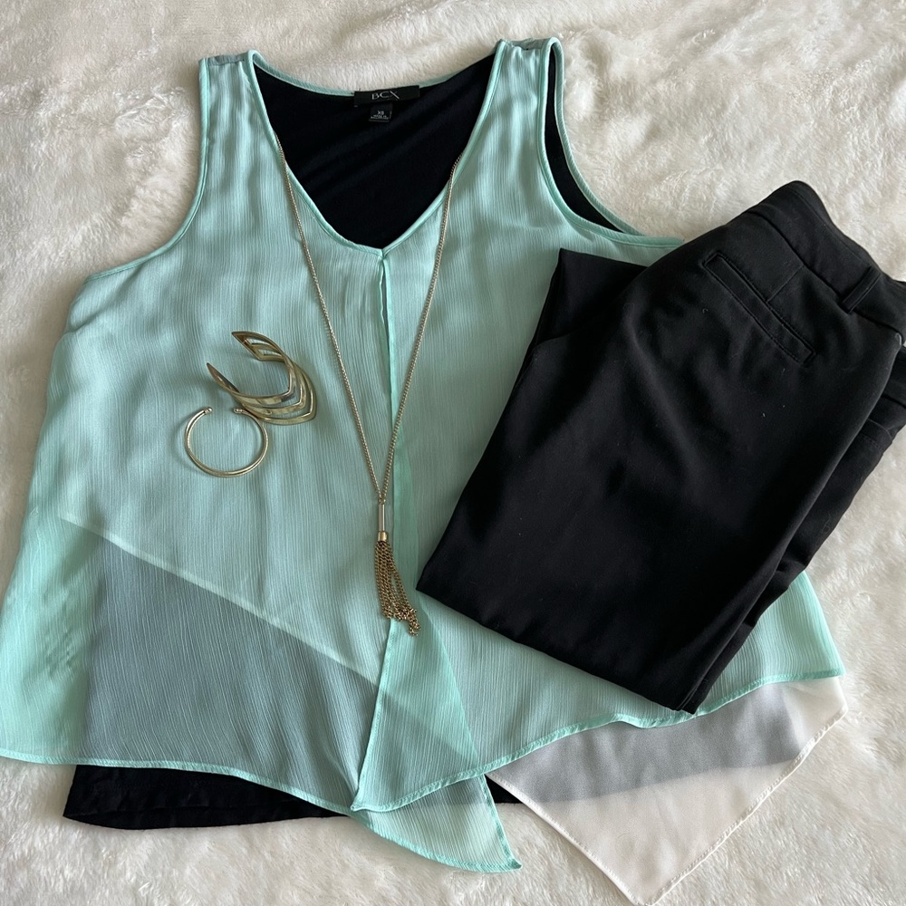 Multi layer tank top comes with attached necklace.
